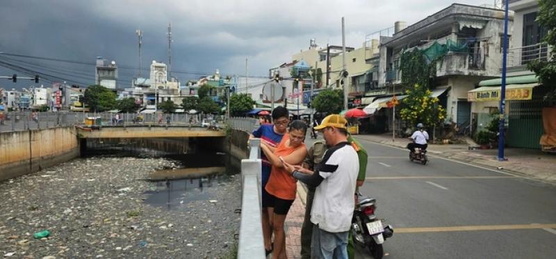 Người dân tập trung quanh bờ kênh xem lực lượng chức năng tìm bắt cá sấu- Ảnh 4. Người dân tập trung quanh bờ kênh xem lực lượng chức năng tìm bắt cá sấu- Ảnh 4.